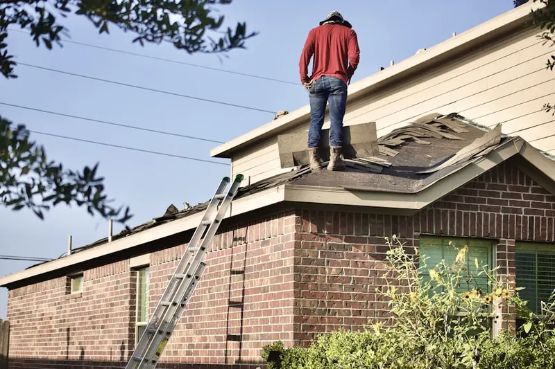 Professional roofer working on a residential roof in East Cutchogue